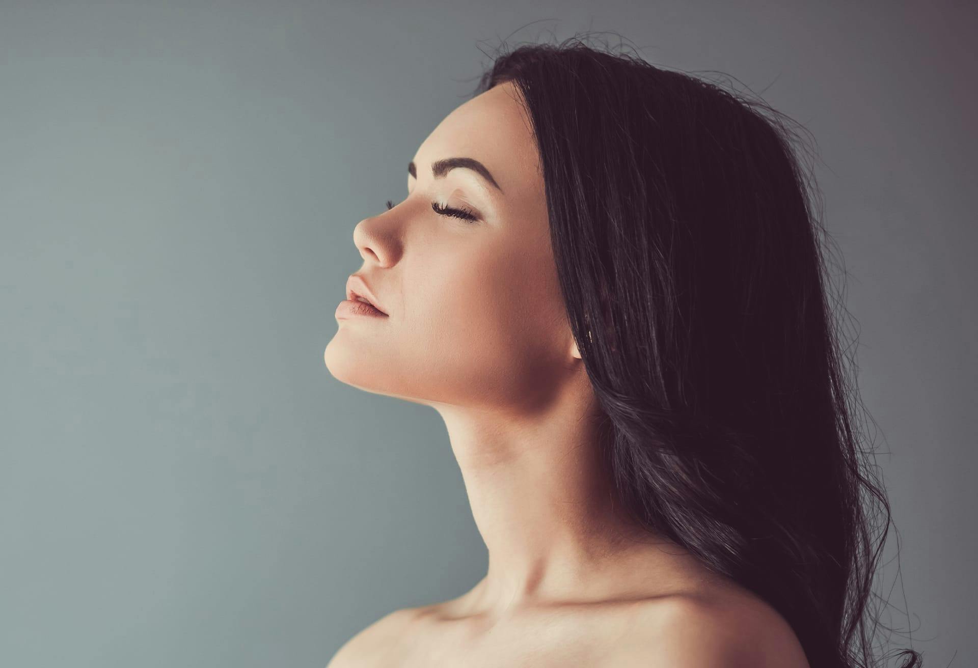 Woman Looking up with her Eyes Closed