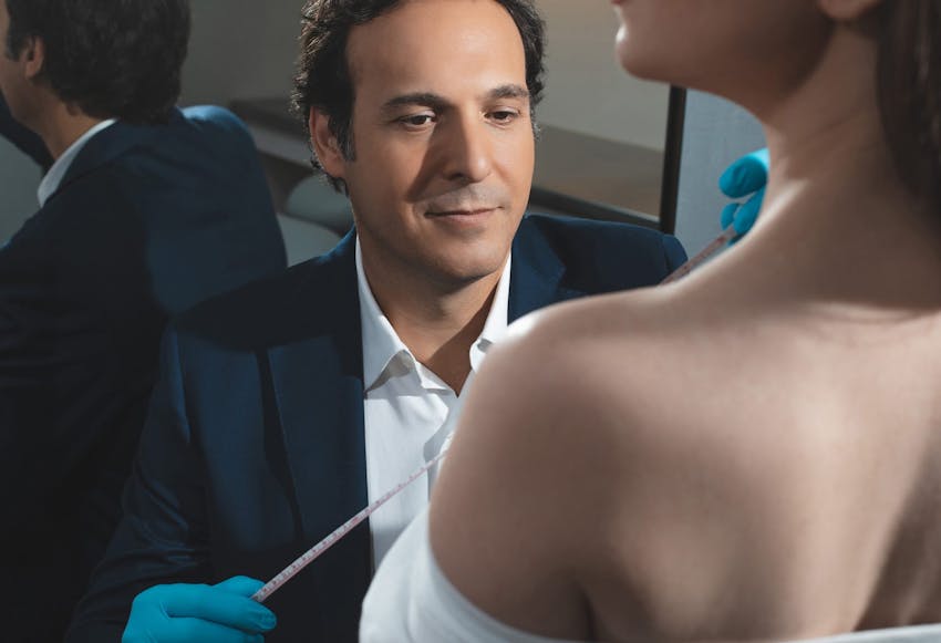 Dr. Hyman measuring a Woman's Chest