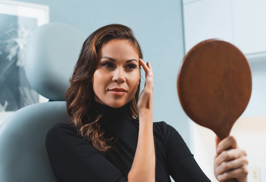 Woman Looking at her Results in the Mirror