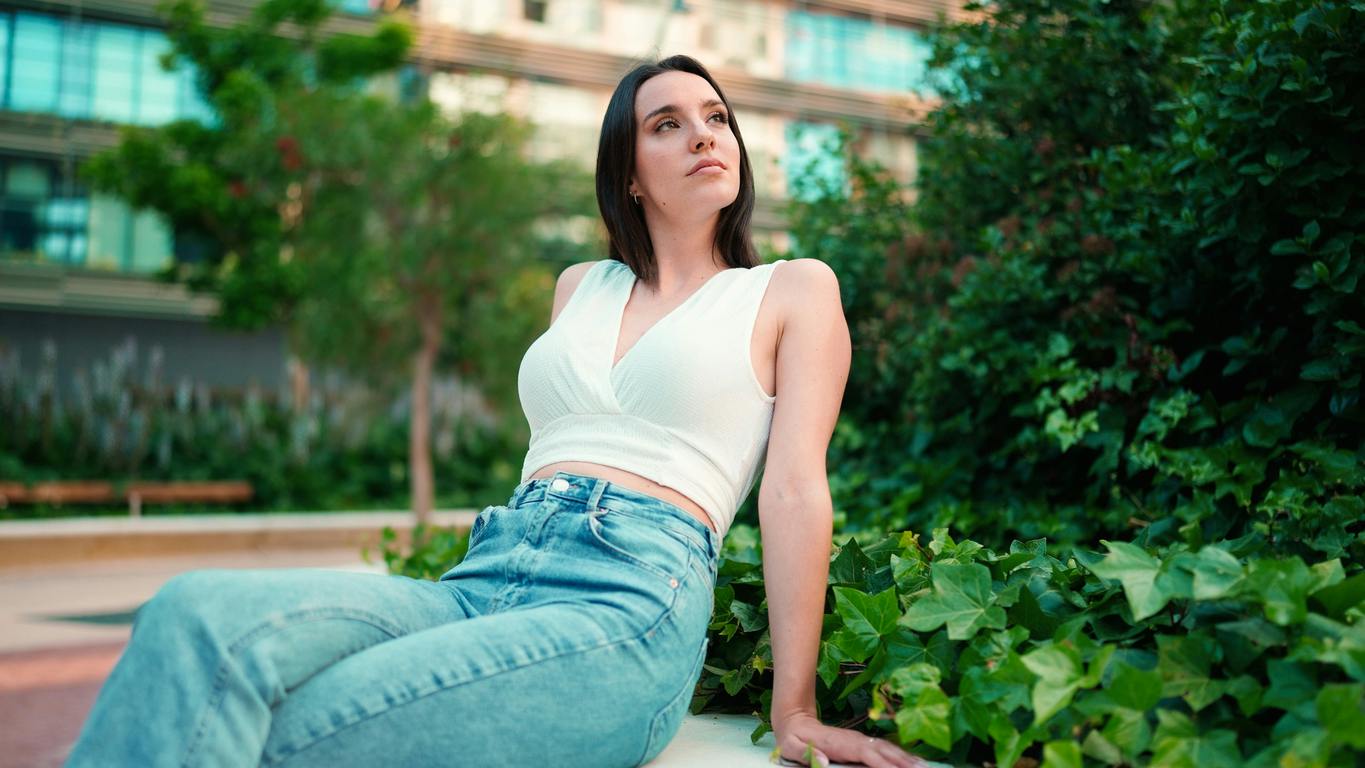 woman wearing jeans and a white top