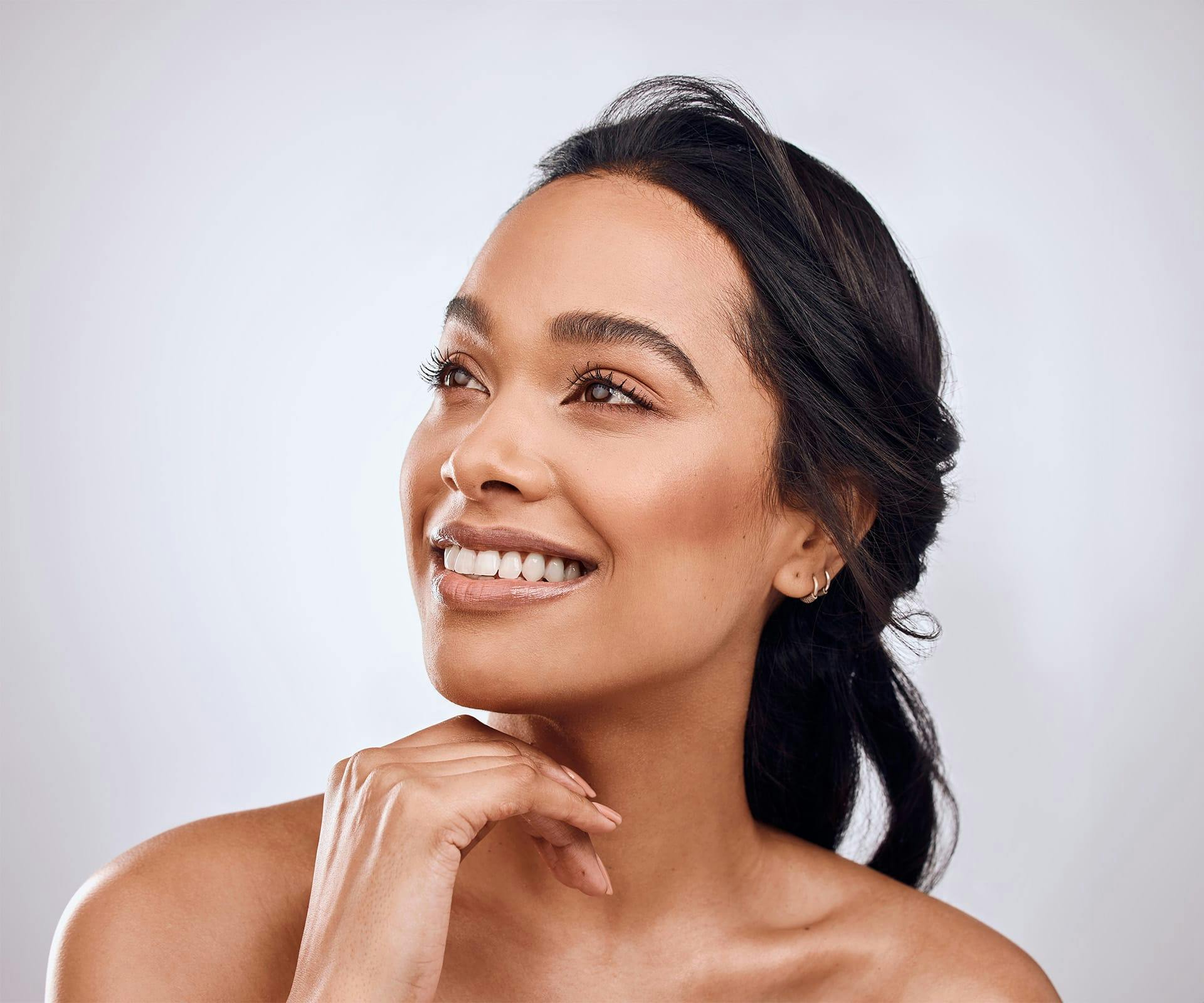 a woman smiling after seeing an emergency dentist in Bluffton and Hilton Head