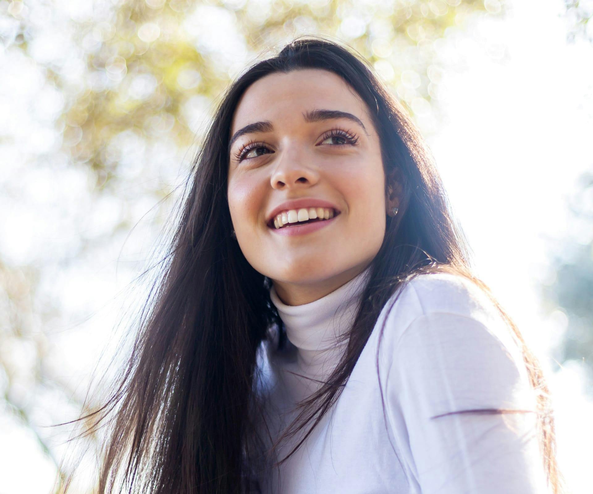 woman in turtleneck smiling