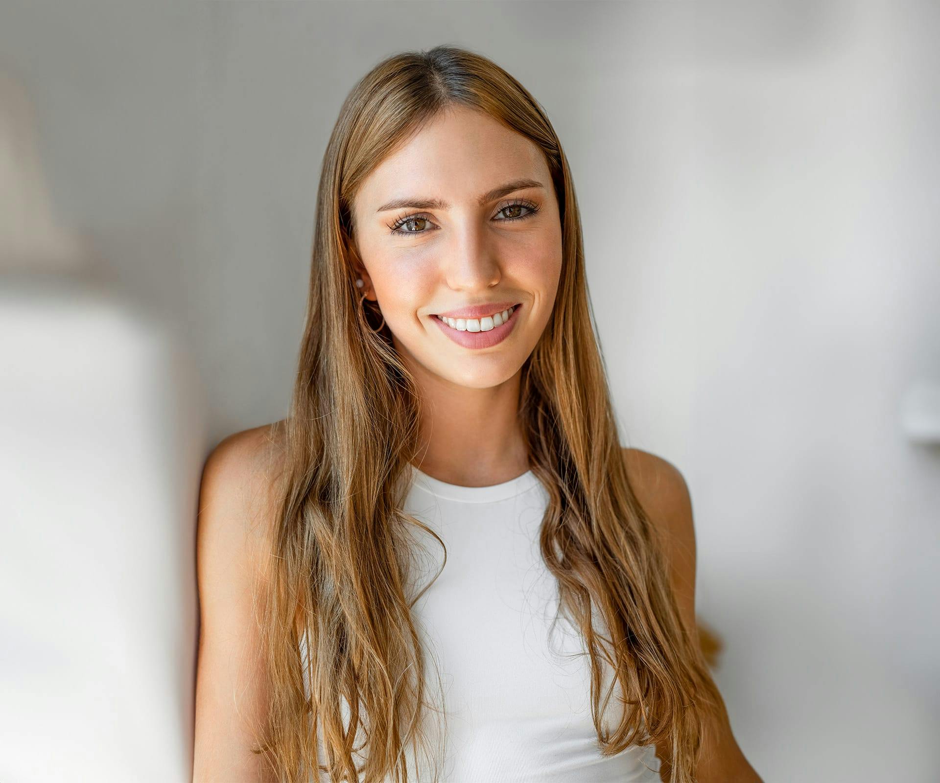 a woman smiling after getting tooth colored fillings in Hilton Head and Bluffton