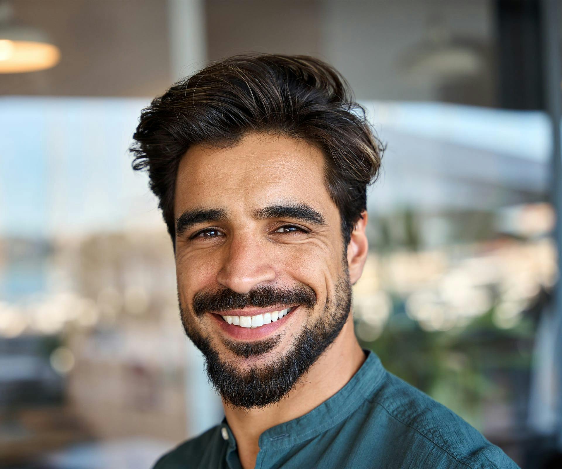 a man smiling and looking at the camera after getting a teeth cleaing and dental exam in Bluffton and Hilton Head