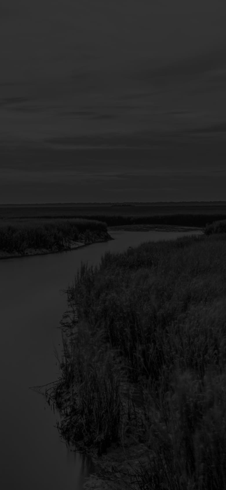 Darkened image of a winding river