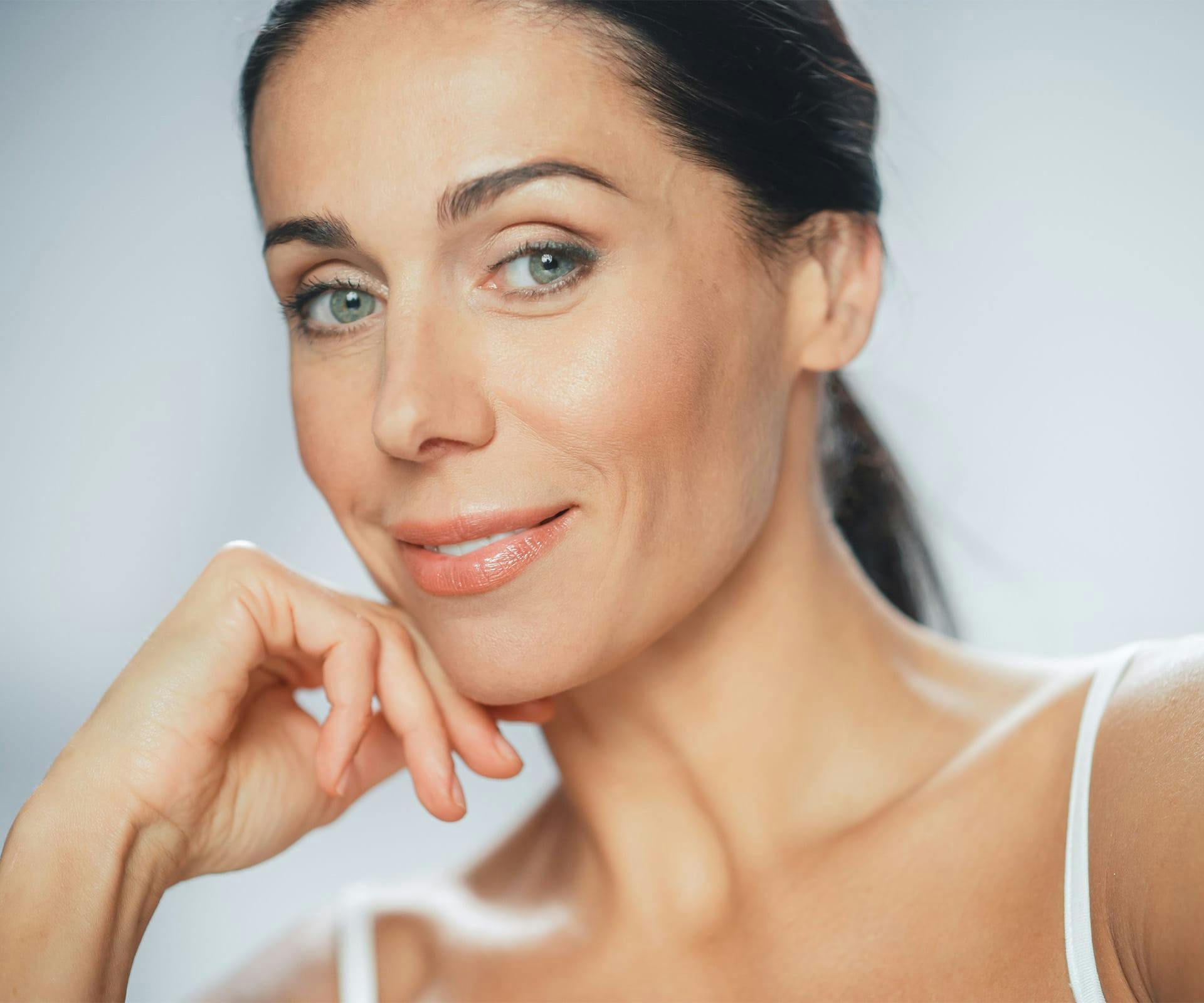 woman resting chin on hand