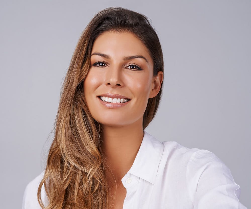 a woman smiling with clean teeth after getting a root canal in Bluffton and Hilton Head