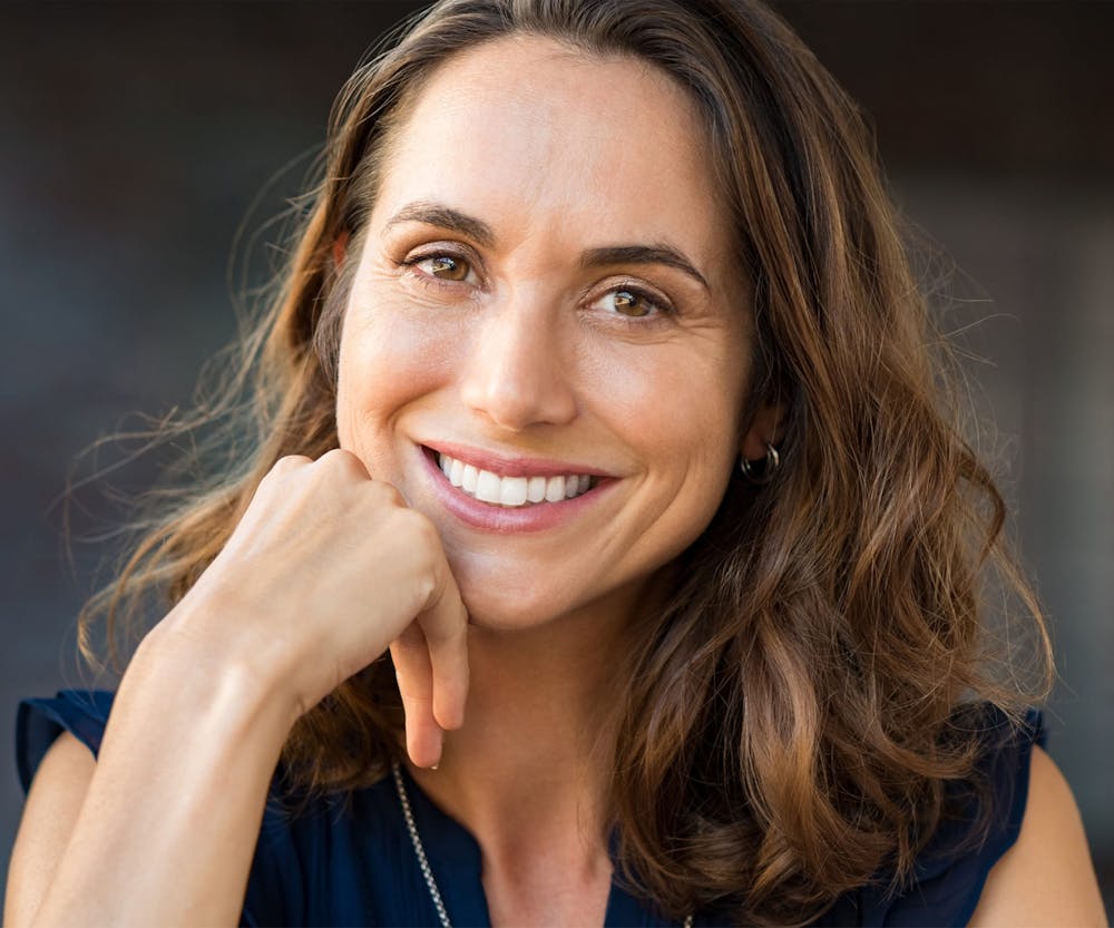 a woman smiling after getting a smile makeover in Bluffton and Hilton Head