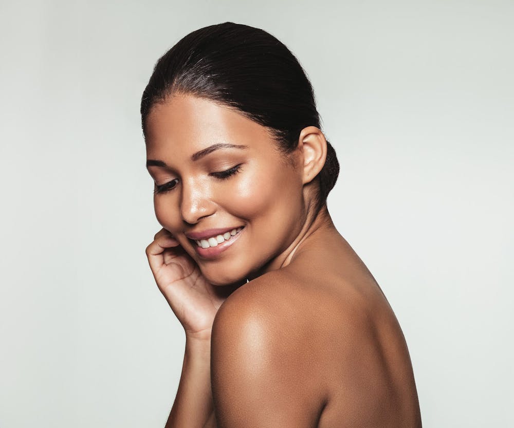 woman looking down with her head leaning over her shoulder