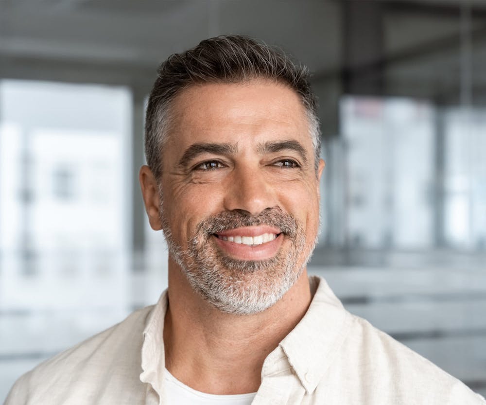 woman with hat on standing in front of wooden panel wall