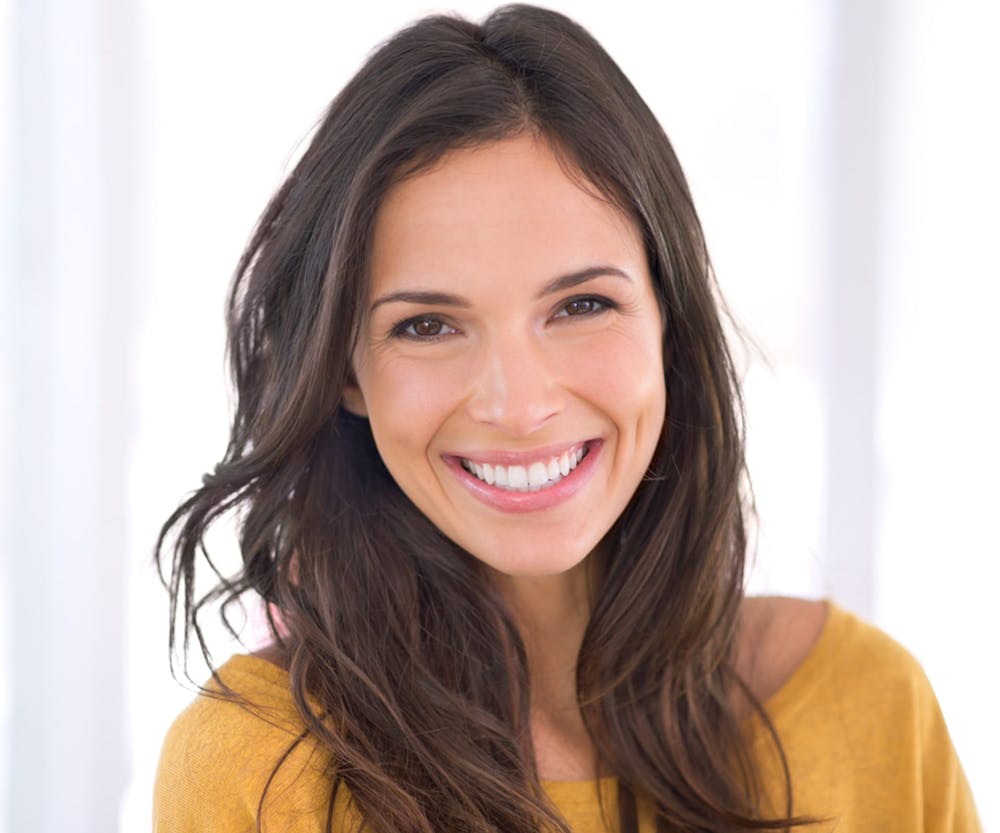 a woman smiling after getting teeth whitening in Bluffton and Hilton Head
