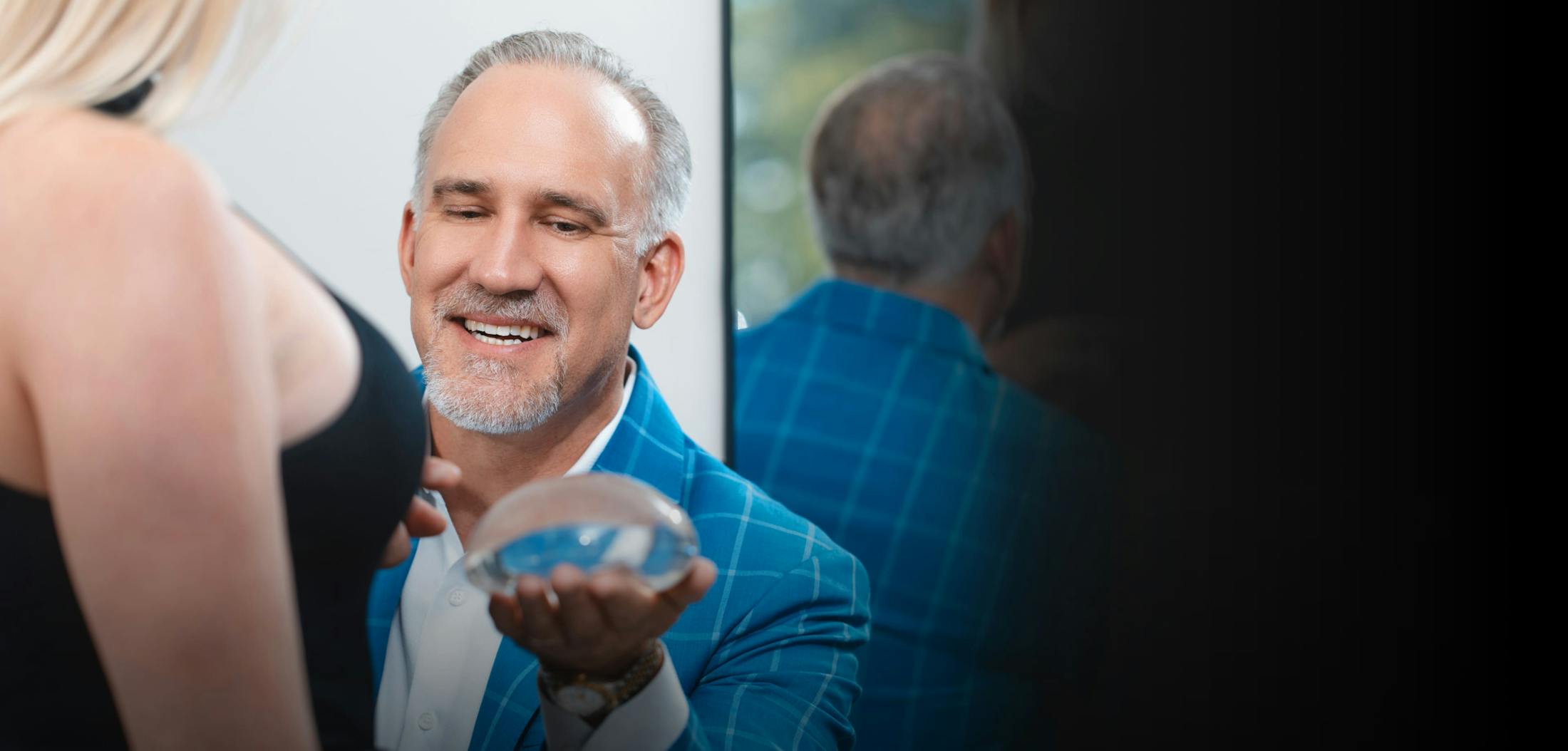 Michael R. Burgdorf talking about breast implants with a female patient