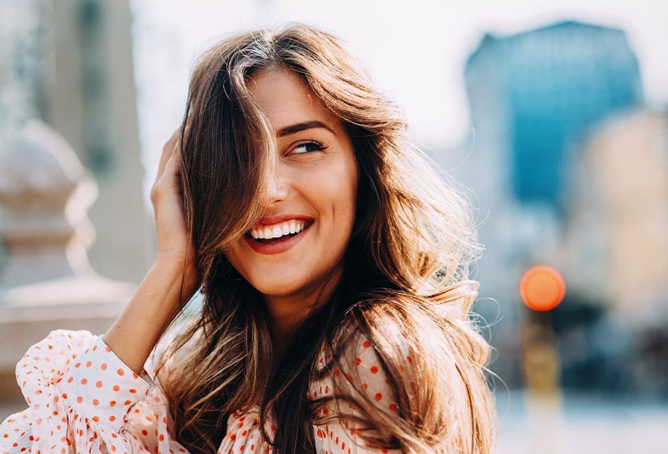 Woman Smiling with Her Hair in Her Face