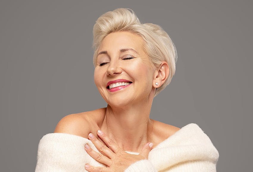 Older Woman Posing in a White Sweater
