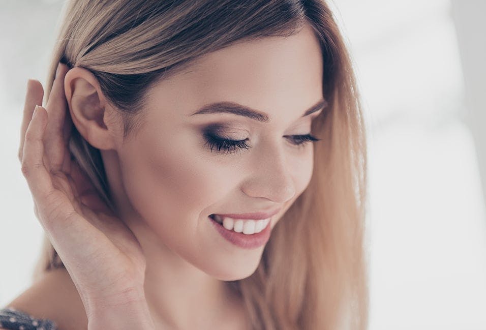 Woman Putting Her Hair Behind Her Ear