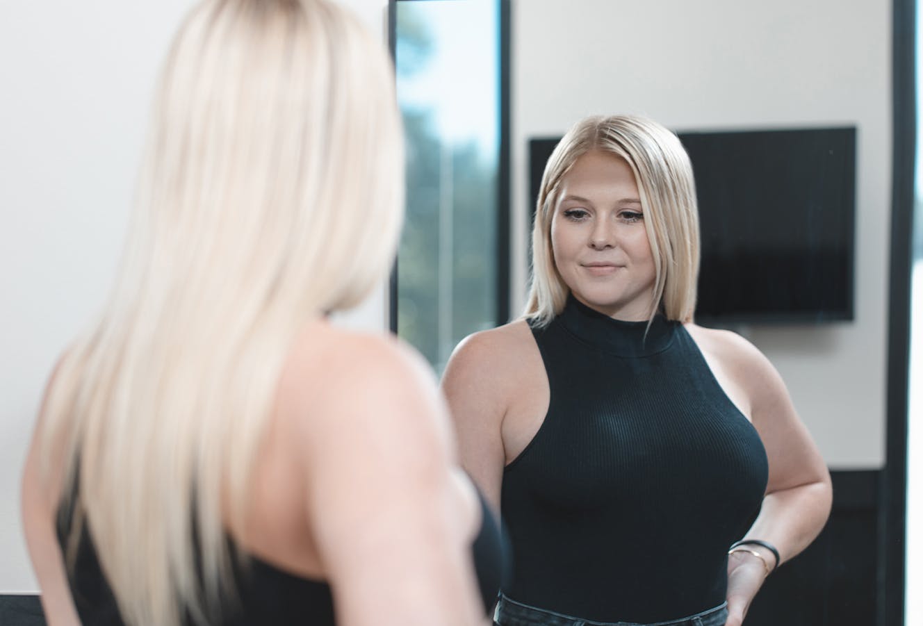 Woman Looking at Her Reflection in the Mirror