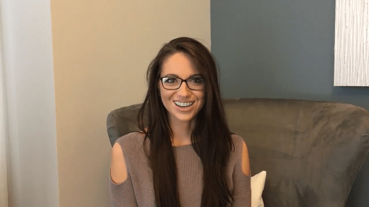 Woman in Glasses Sitting on a Chair