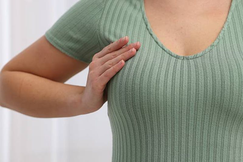Woman's Breast in a Green Shirt
