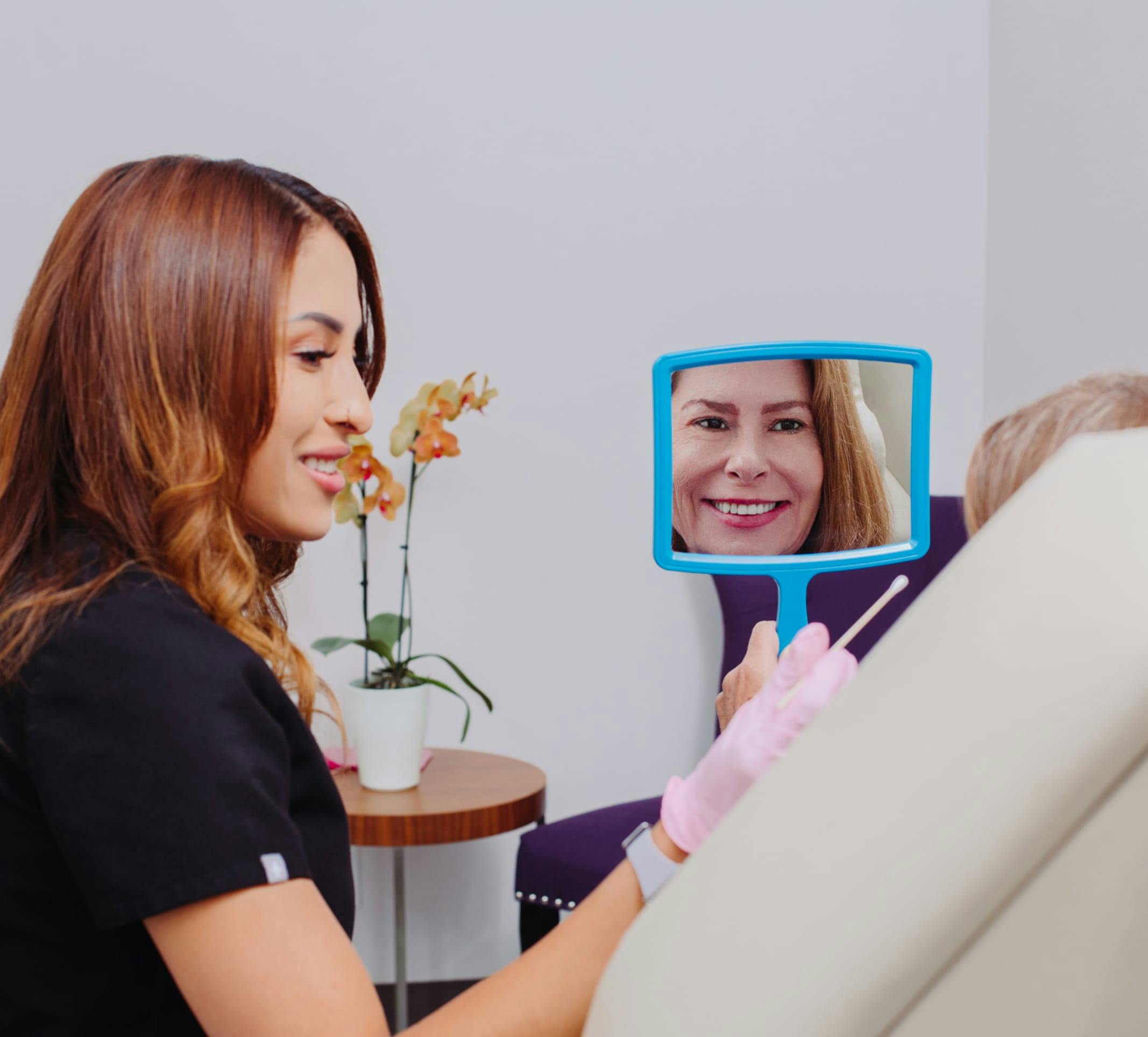 woman looking in a handheld mirror