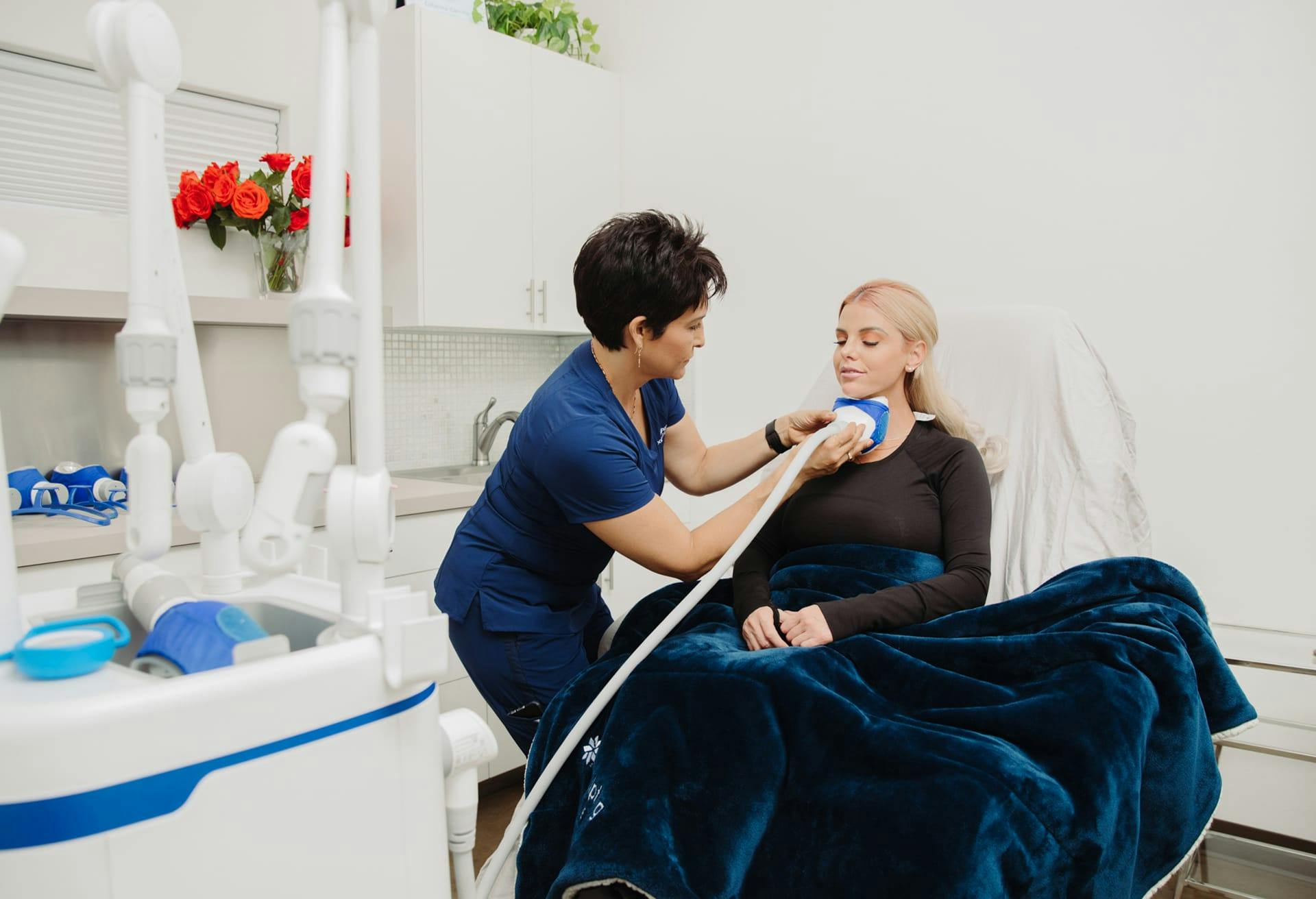 Female patient receiving CoolSculpting treatment at Flawless Med Spa in Albuquerque