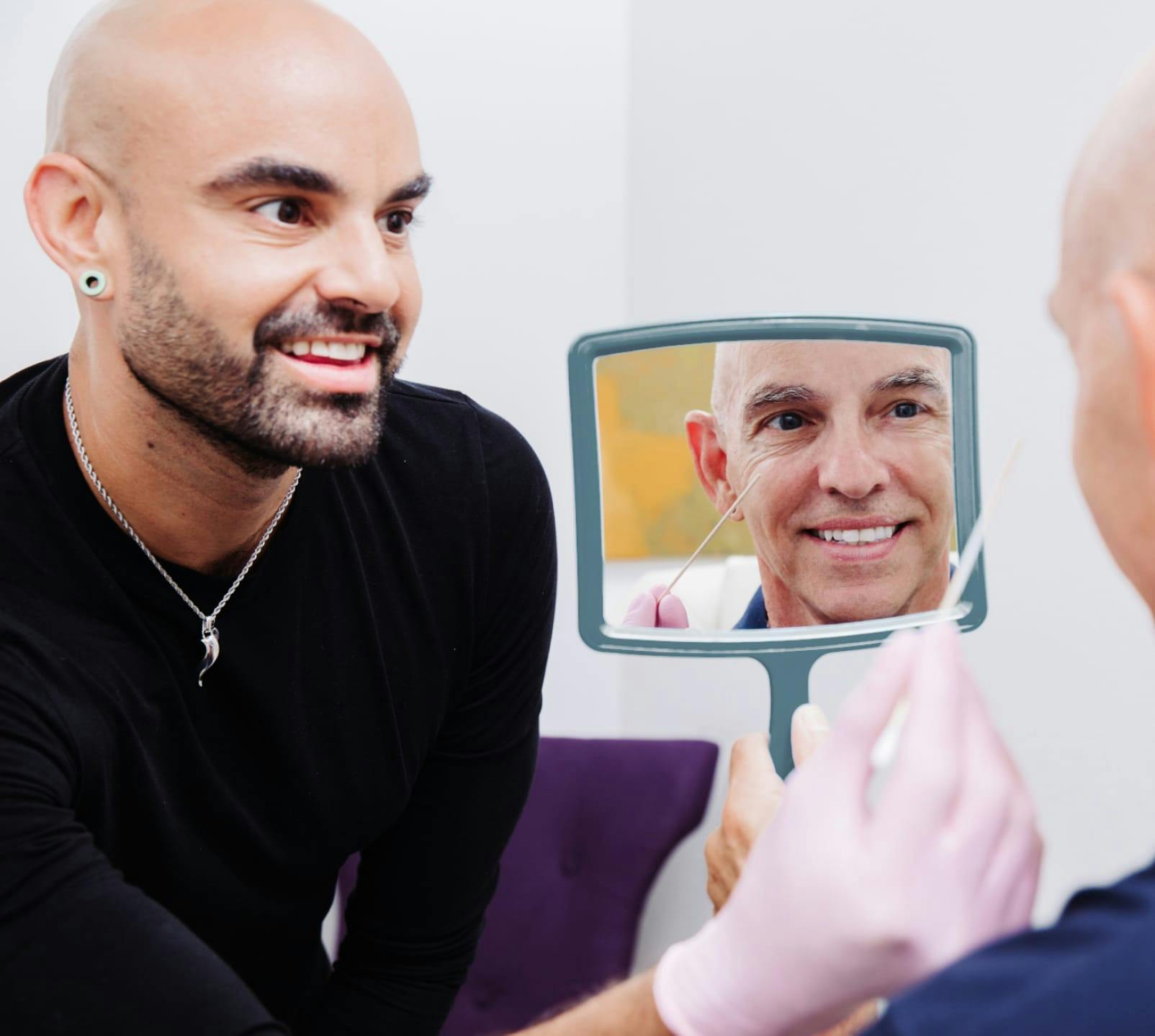 Patient looking in a mirror while being helped by the staff at Flawless Med Spa.