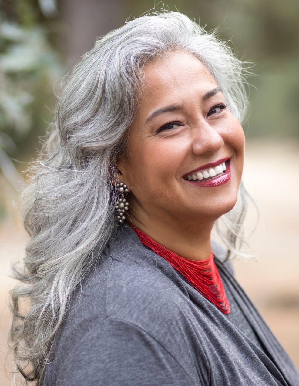 Woman with grey hair smiling.