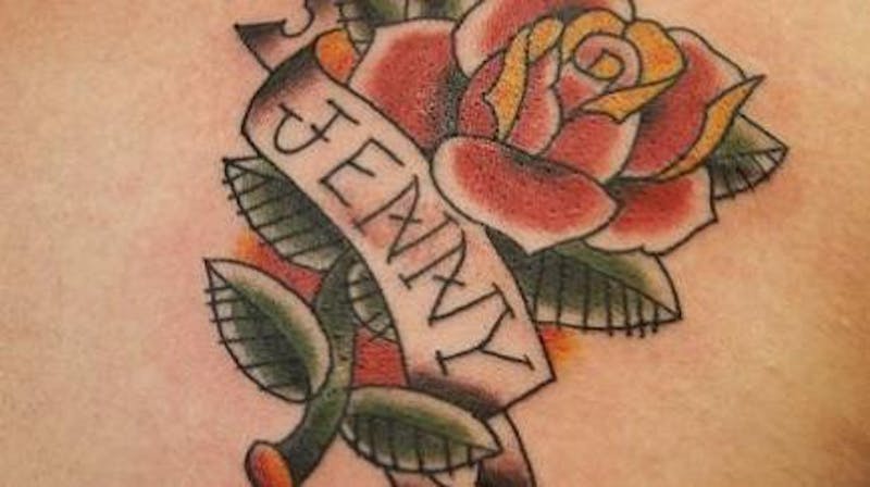 flower tattoo that says Jenny