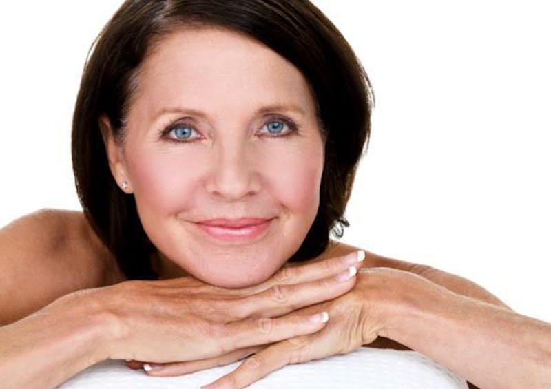 woman resting her face on her hands