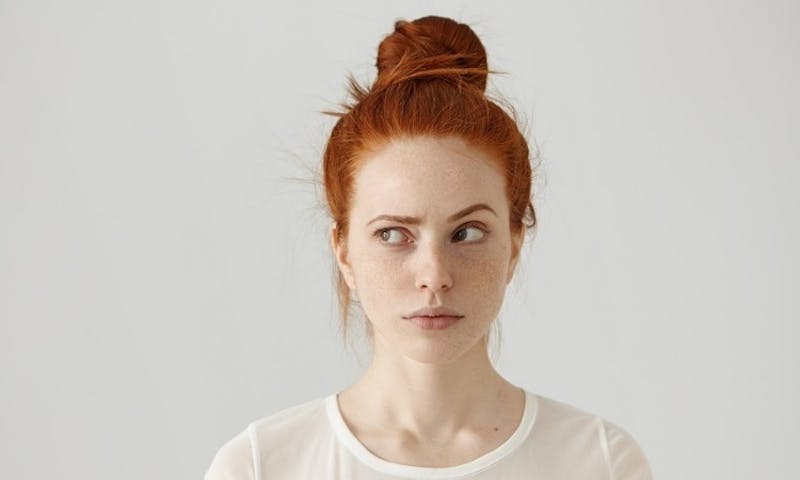 woman with a red hair and a white shirt