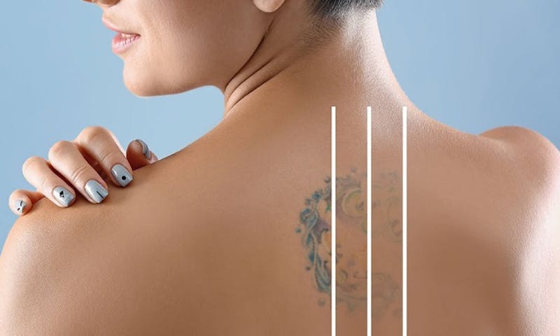 a close up of a woman with a tattoo on her back