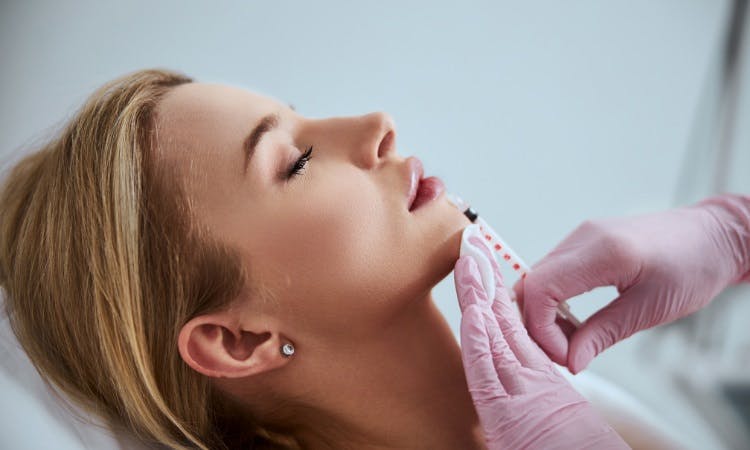 a woman getting lip fillers
