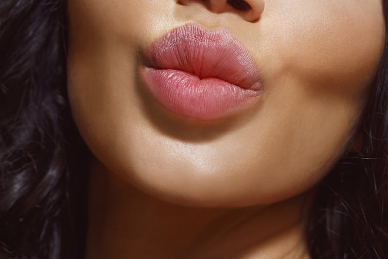 there is a close up of a woman's lips with a black background