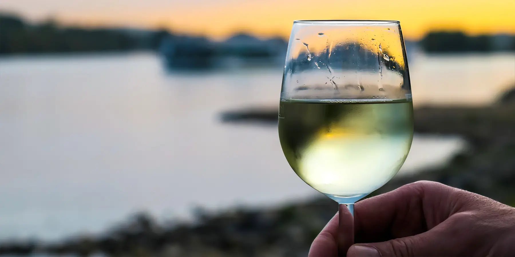 A glass of chilled white wine as the sun sets