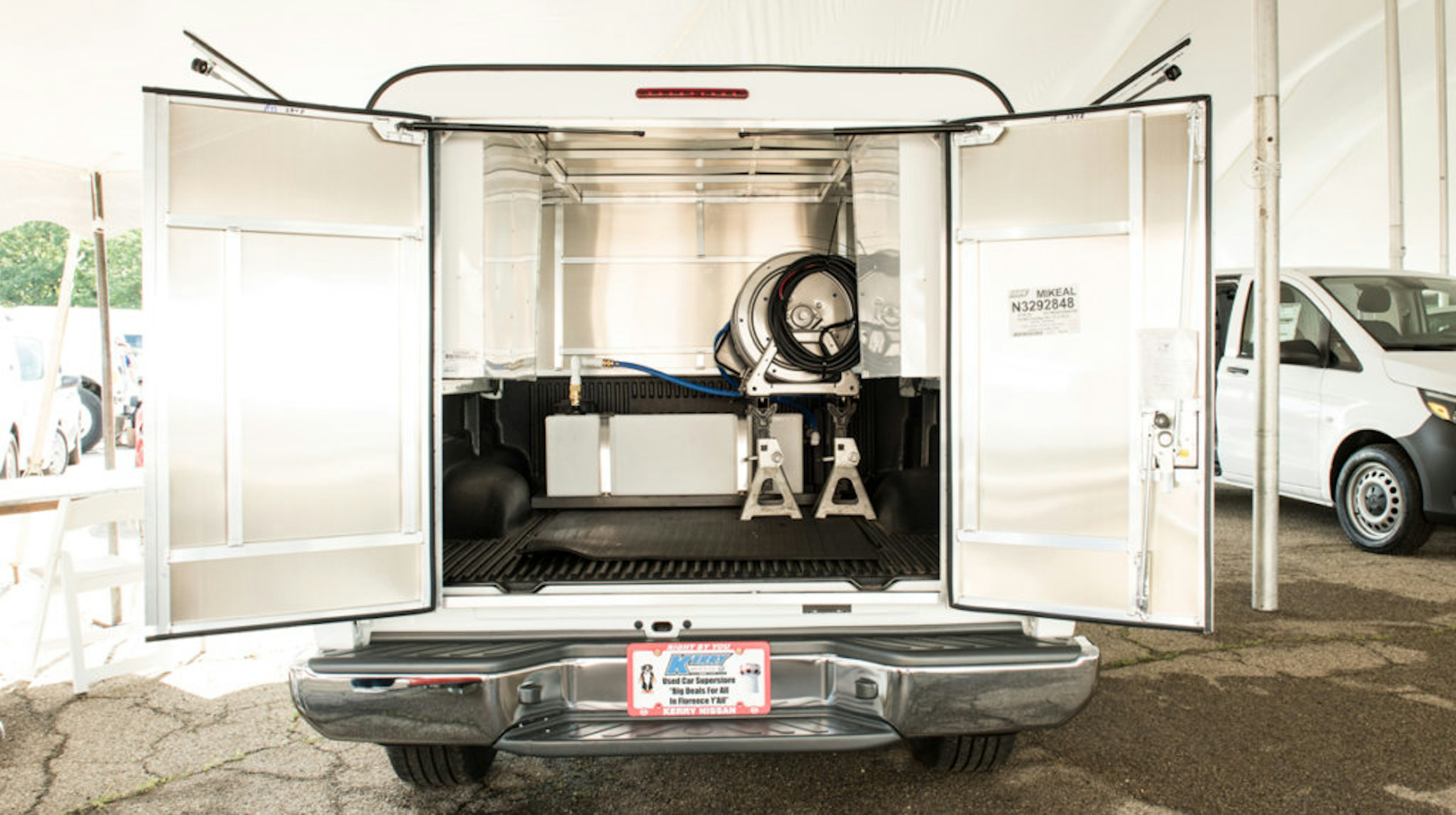 rear view of pest control truck with the twin doors open