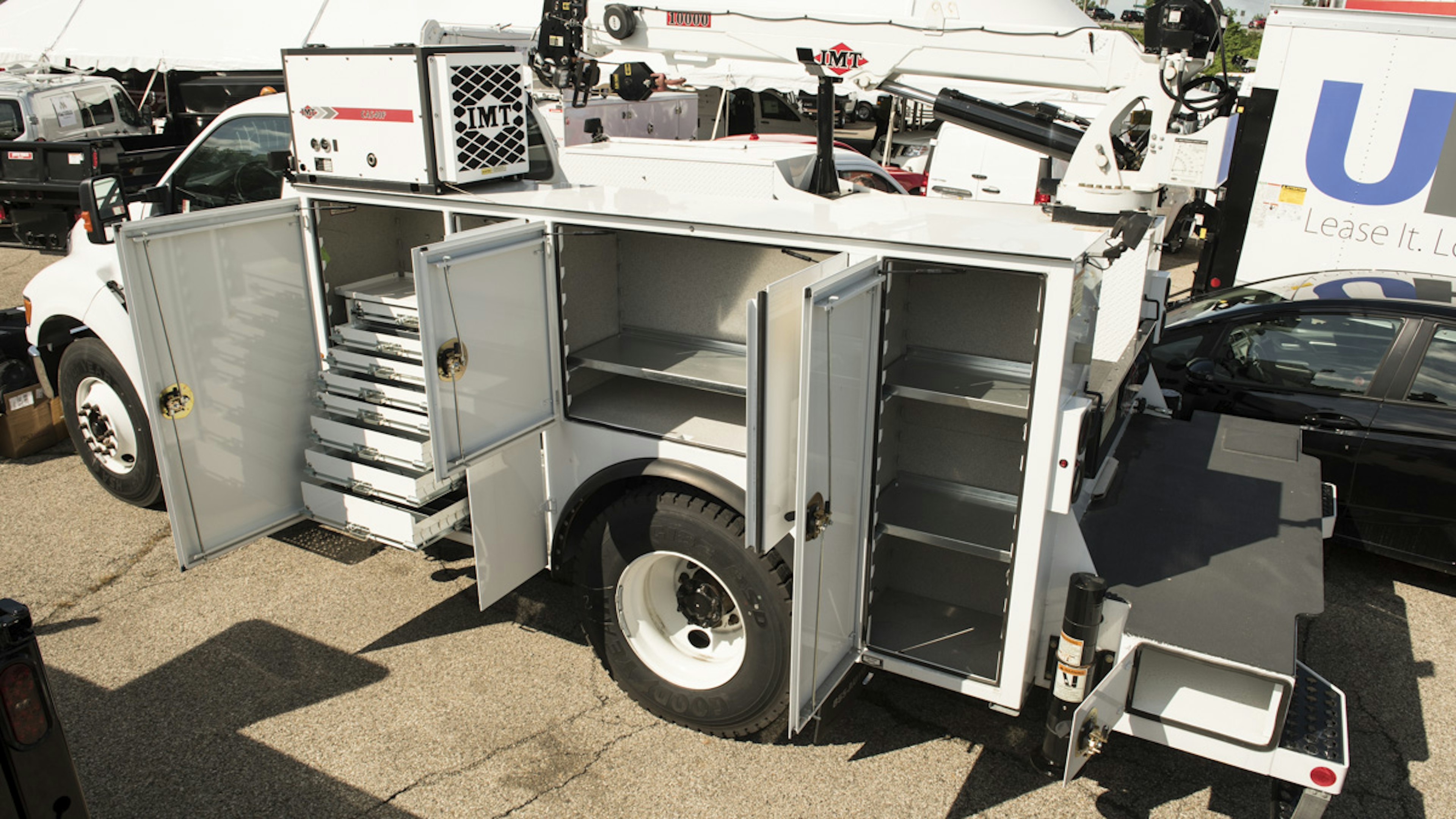 utility accessories such as tool boxes and generator on the back of a medium service truck