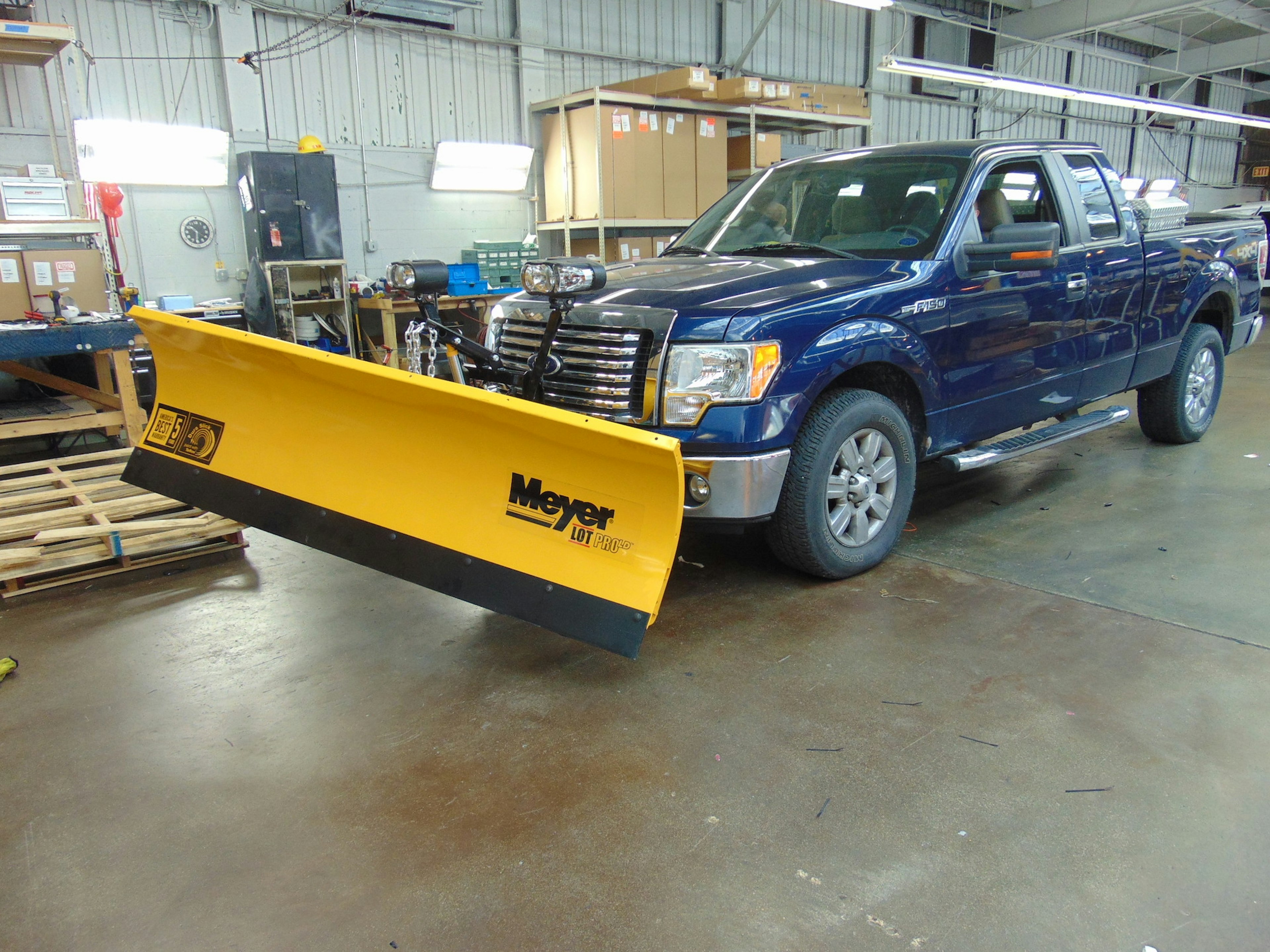 Pickup Truck carrying Snow Plow Attachment Ready for Winter