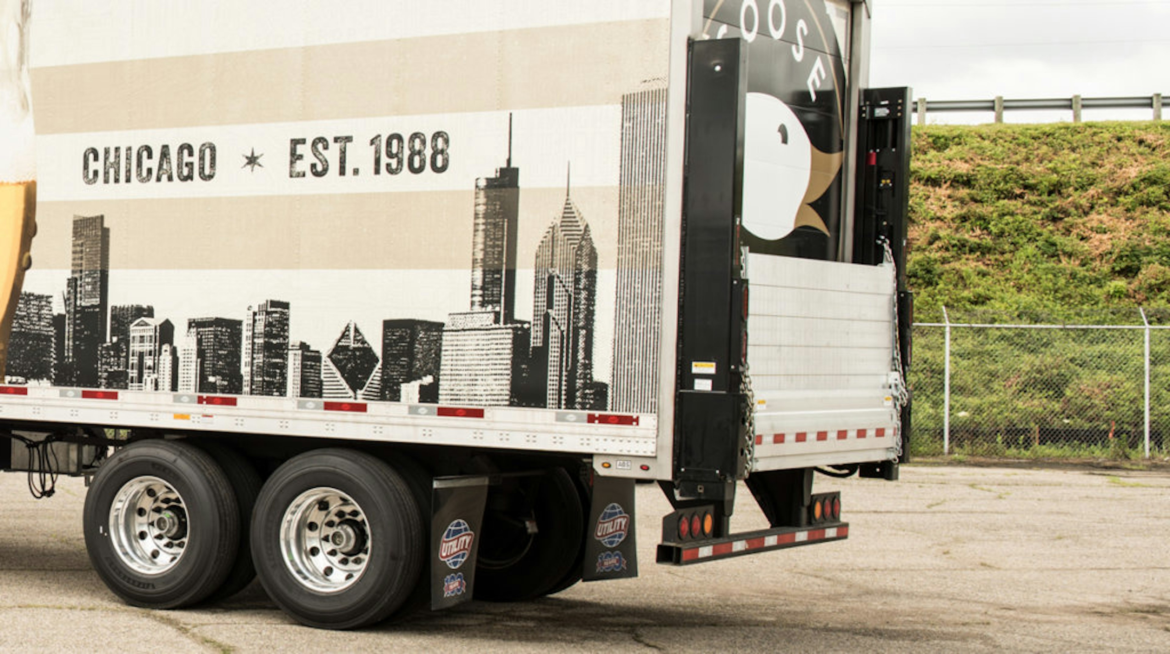 Delivery trailer with mounted lift and branded wrap