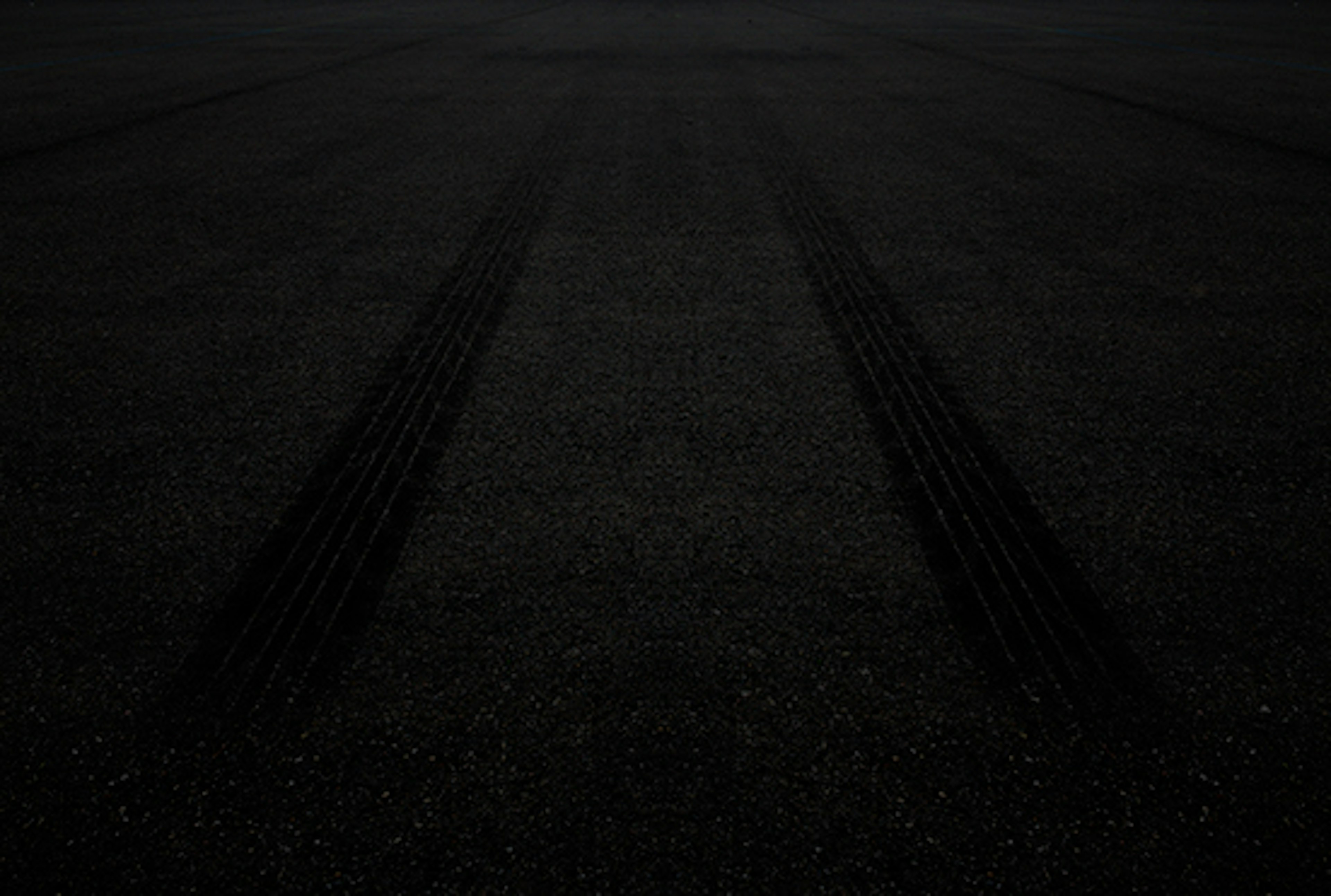 Tire tread on black top from a fleet vehicle.