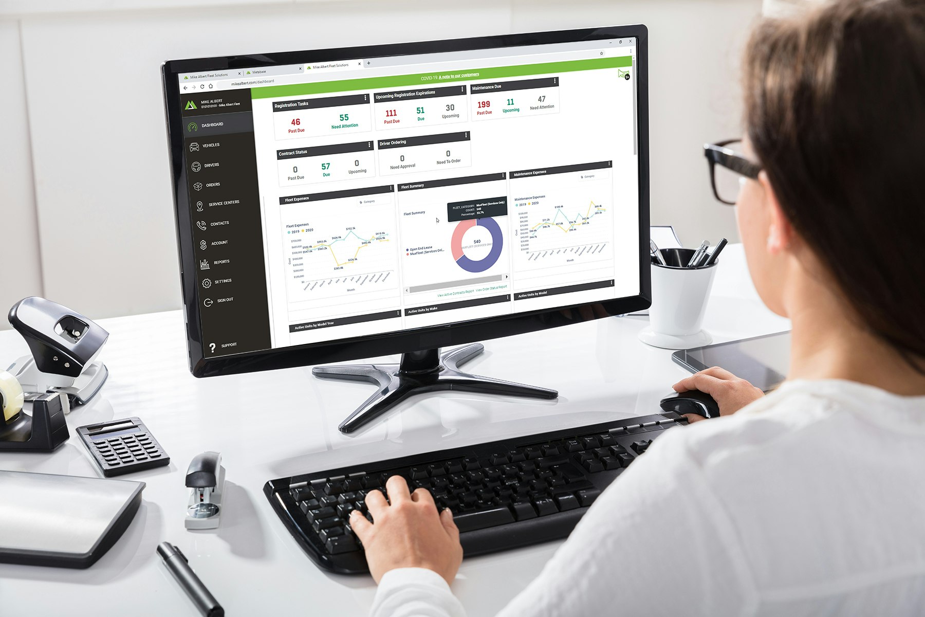 Woman Reviewing the Mike Albert Dashboard on Desktop