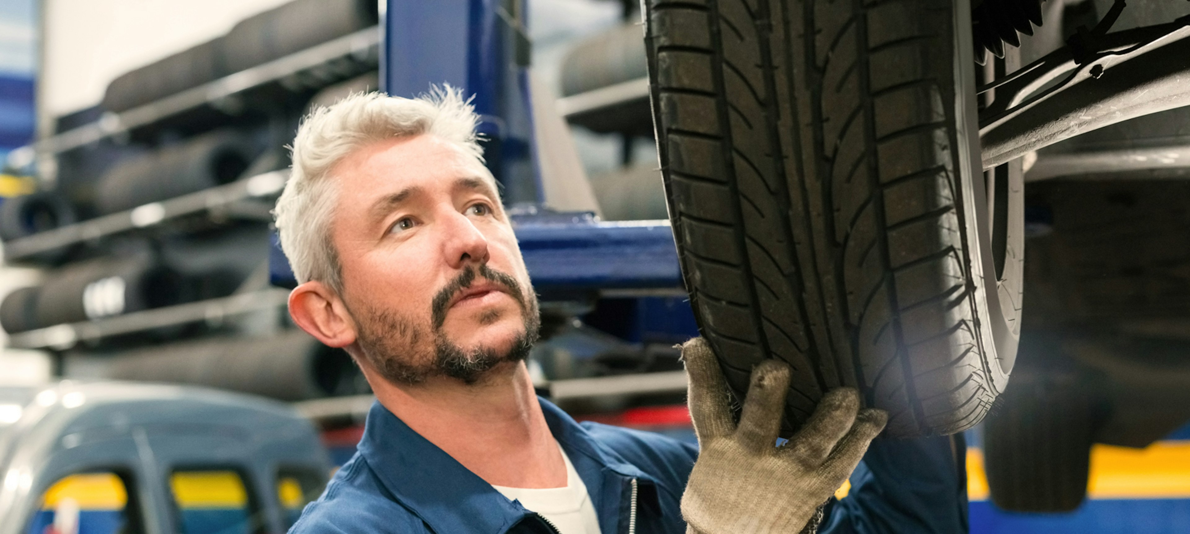 Worker inspecting fleet vehicle 