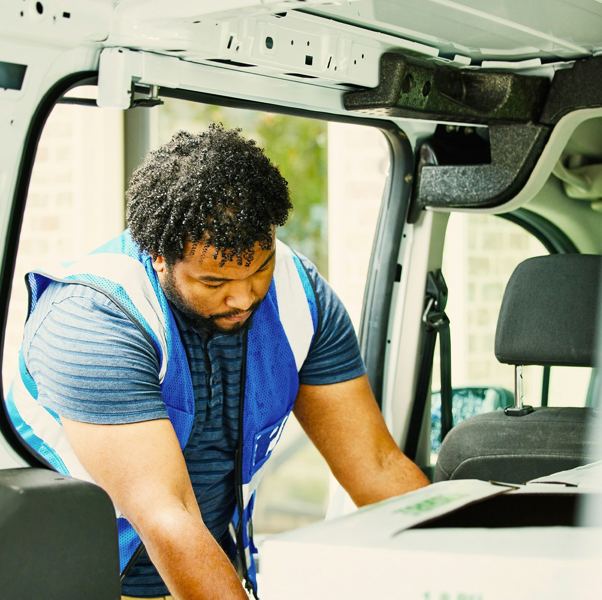 Man unloading boxes from Mike Albert fleet vehicle