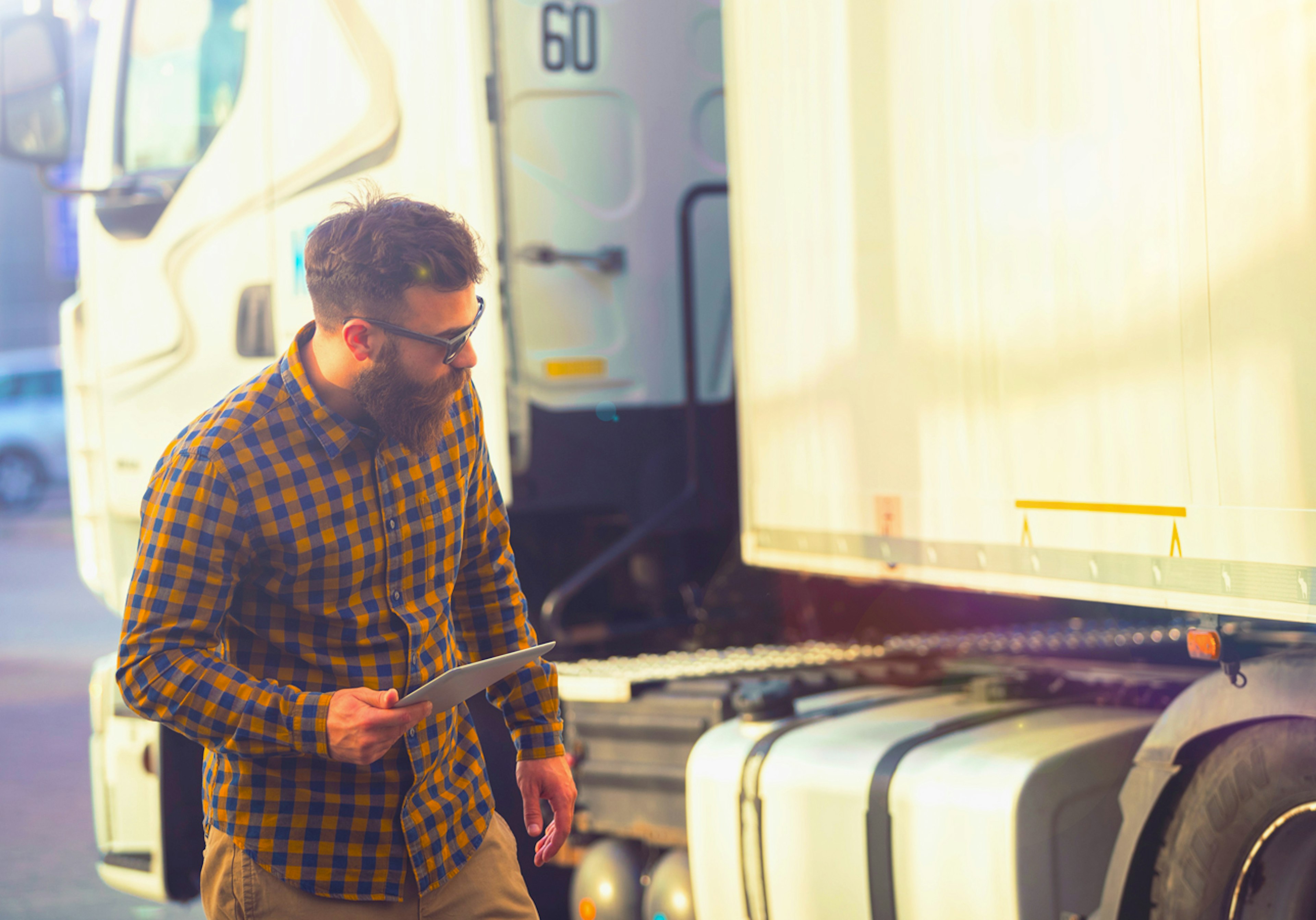 Man checking truck for DOT compliance.