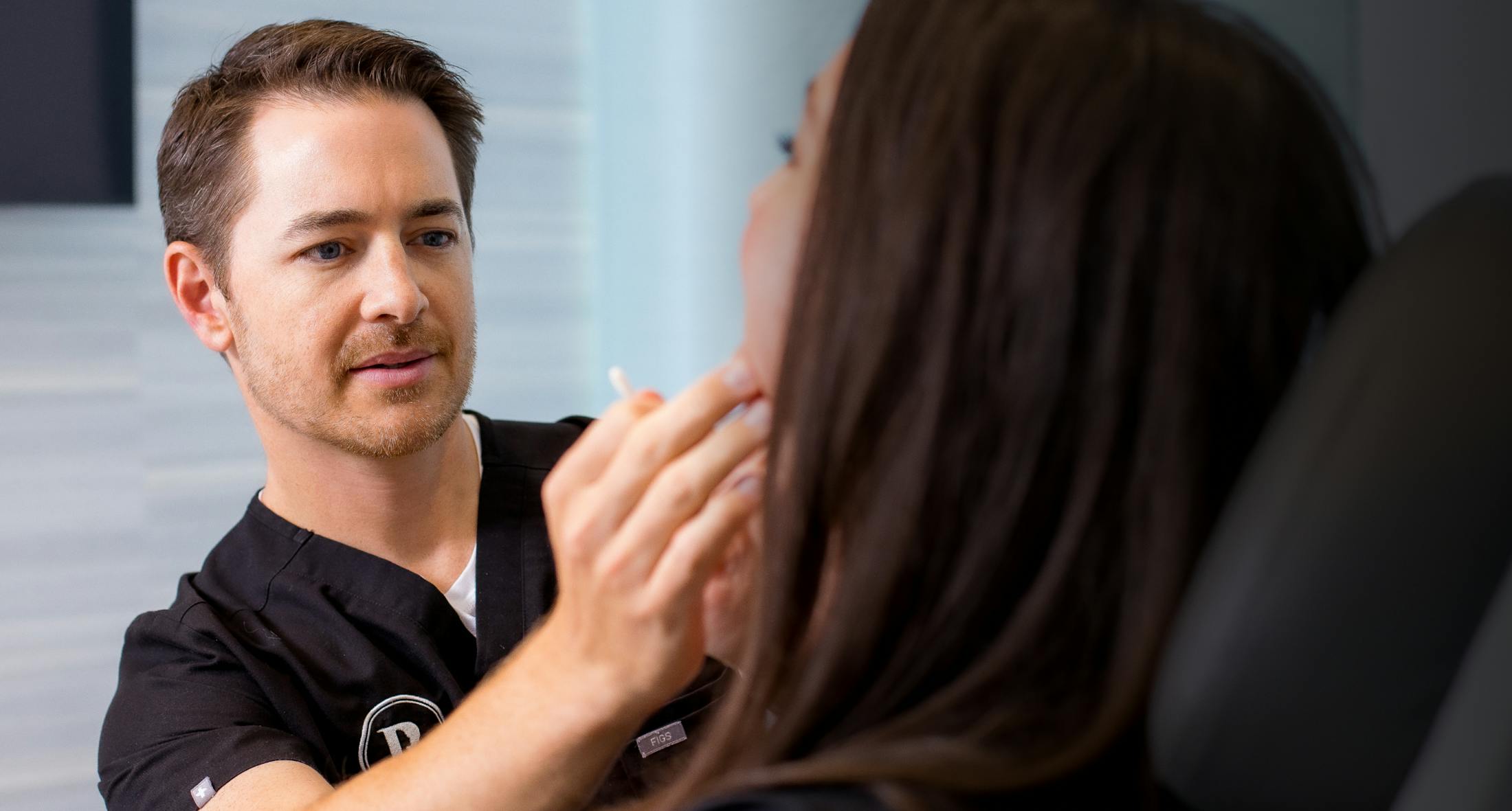 Plastic Surgeon, Dr. Robb, working with a patient.