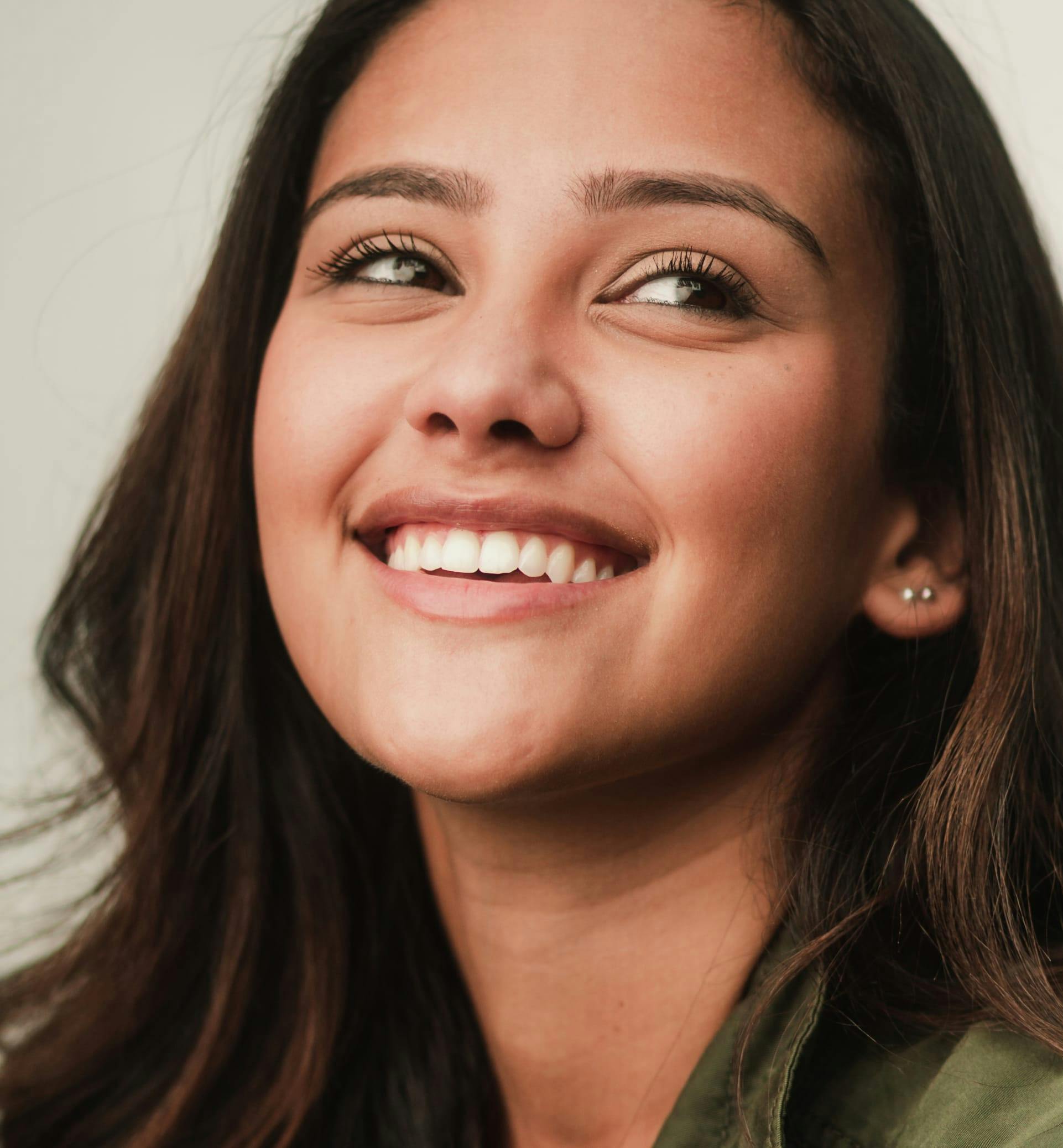 Closeup of a girl's face while she's smiling.