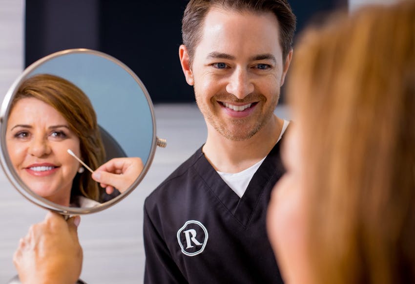 Facial Plastic Surgeon, Dr. Robb, helping a patient.