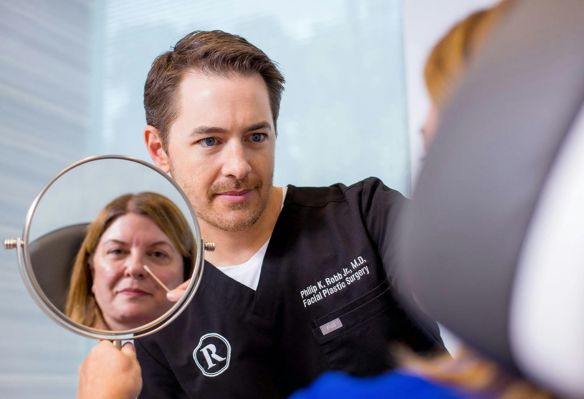 Dr. Robb doing a facial consultation with a potential patient