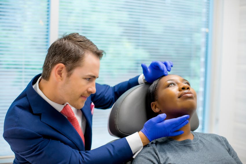 Facial plastic surgeon, Dr. Robb, working with a patient.