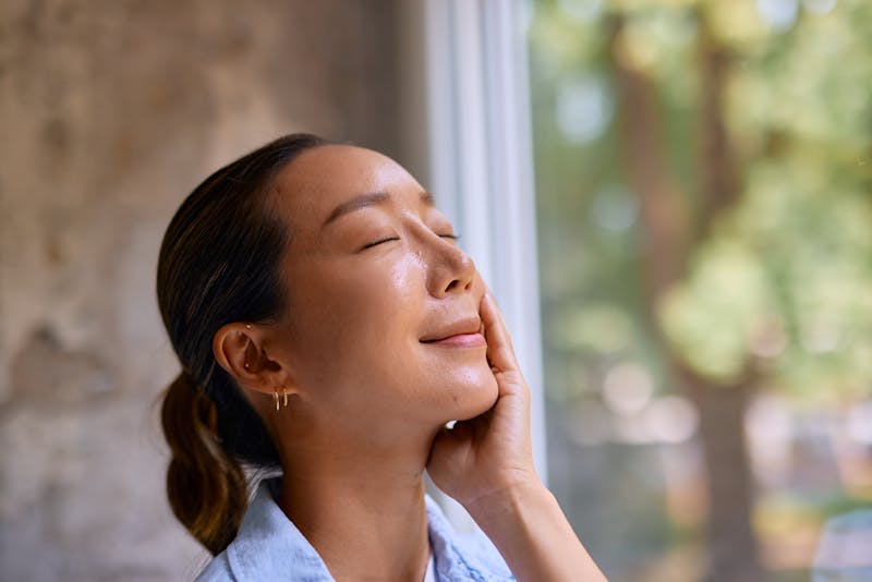 woman holding her face