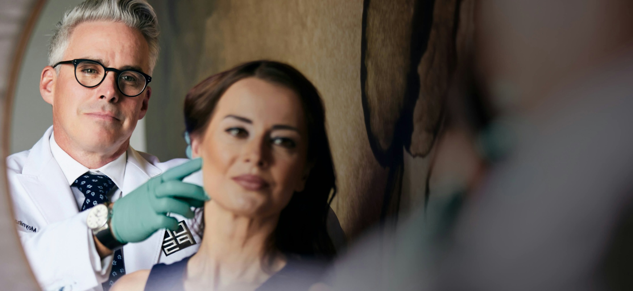 Dr. George Moynihan with patient both looking at mirror