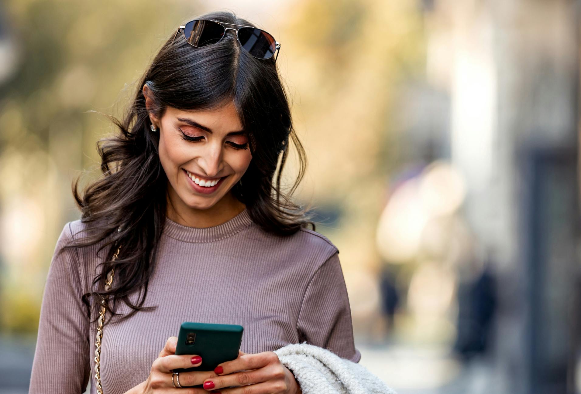 Woman smiling and looking at phone